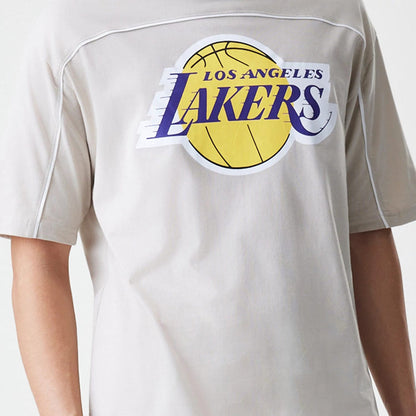 The Male model is wearing LA Lakers NBA Piping Light Beige Oversized T-Shirt 6
