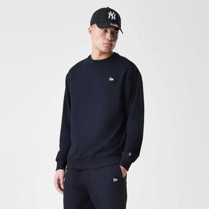 The Male model is wearing New Era Premium Essential Black Oversized Crew Neck Sweater 3