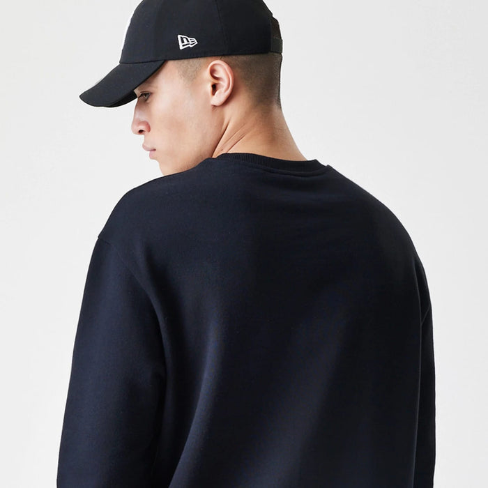 The Male model is wearing New Era Premium Essential Black Oversized Crew Neck Sweater 7