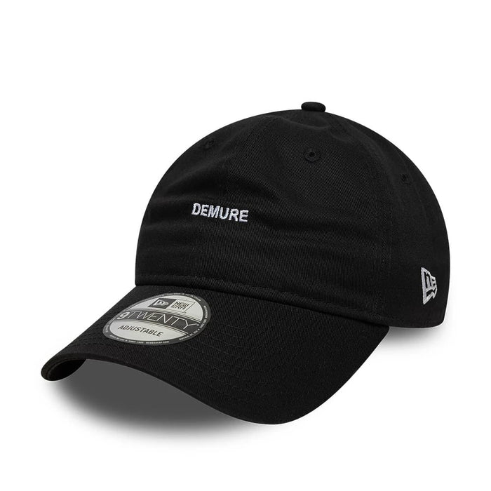 This is a  New Era Slogan Demure Black 9TWENTY Adjustable Cap 1