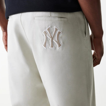 The Male model is wearing New York Yankees MLB Light Beige Chino Trousers 4